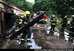 Profesionální a dobrovolní hasiči zasahovali u požáru garáže v Praze -Krči, kterou obývají bezdomovci