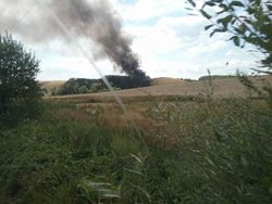 Osm hasičských jednotek zasahovalo u požáru skládky u obce Hradčany na Přerovsku