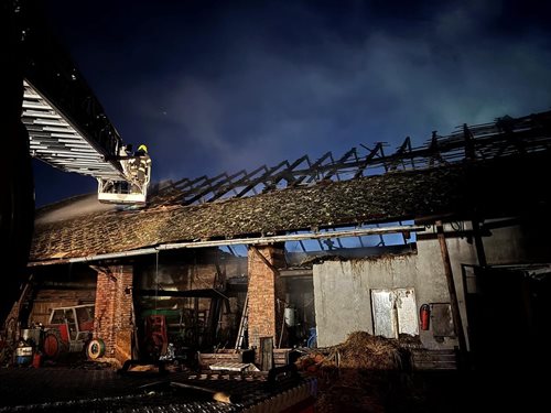 Hasiči v noci zachraňovali zemědělskou techniku ze stodoly v plamenech